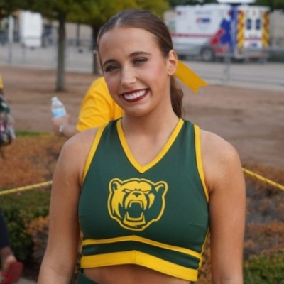 Kendall in her green and gold Baylor cheer uniform